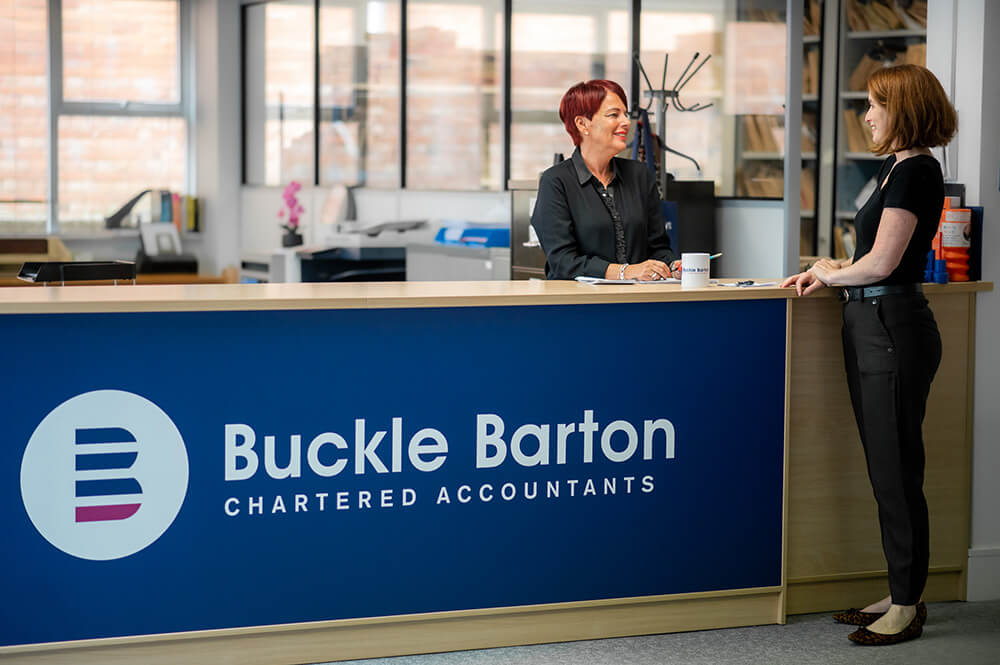 two woman at a reception desk