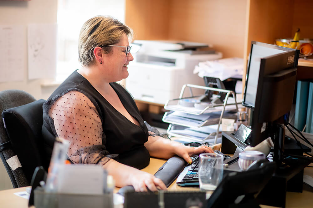 woman at desk on computer