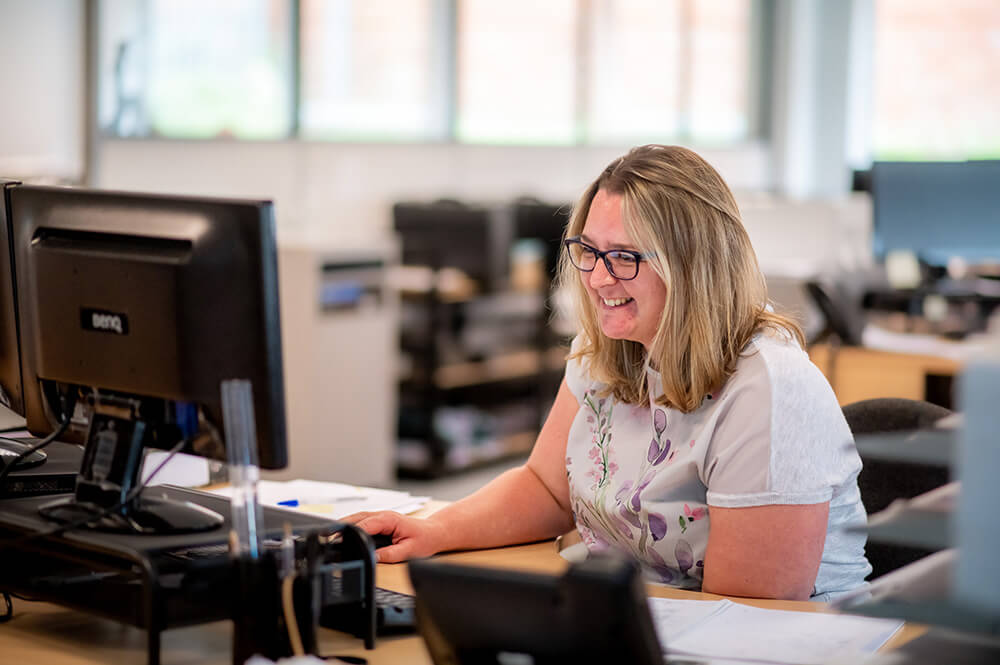 woman at desk on computer